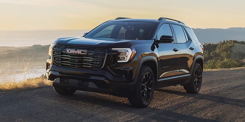 Black GMC Terrain 2026 model exploring off-road terrain with enhanced suspension and capability features.